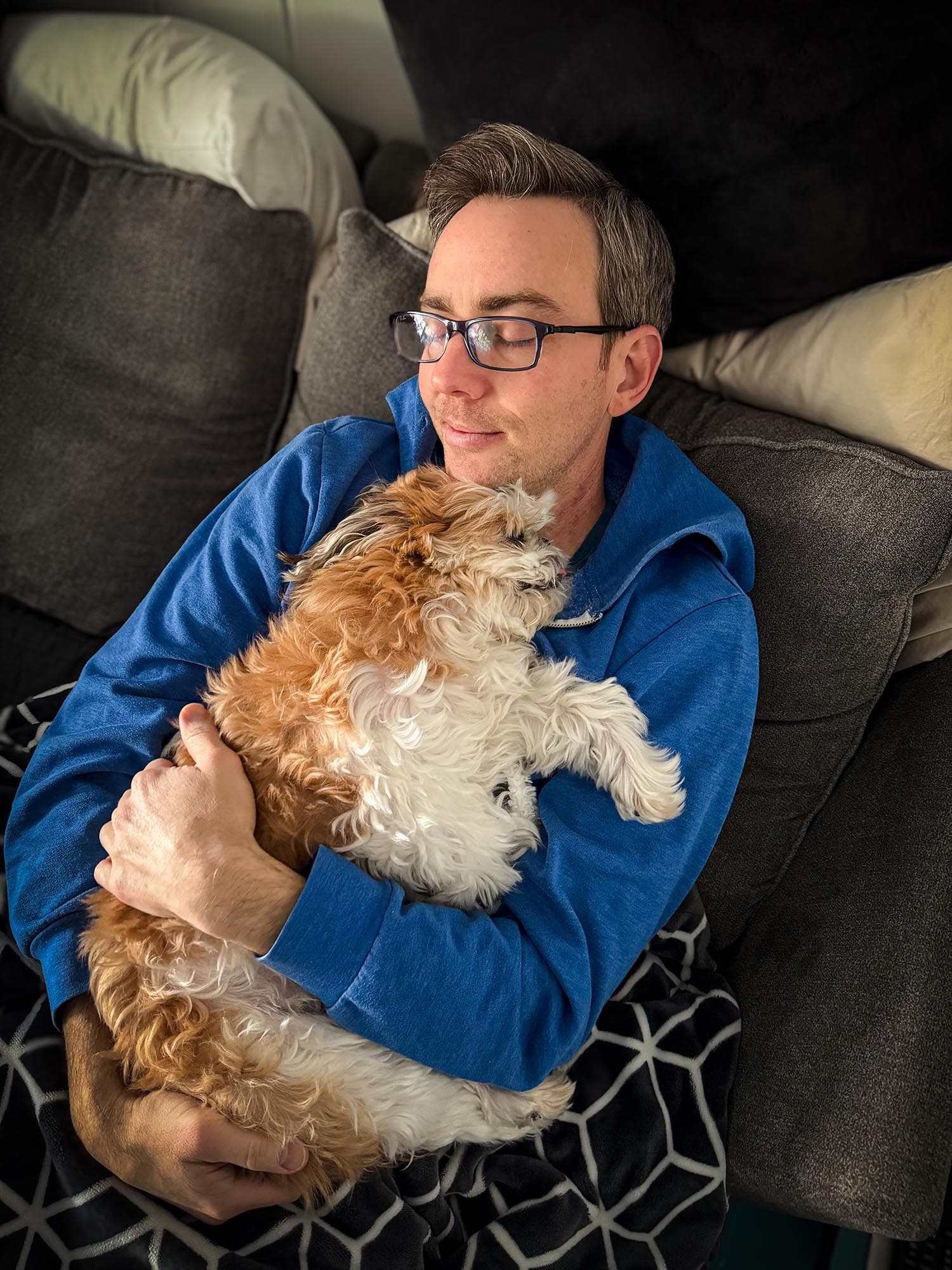 Ryan snuggling Cooper on the couch